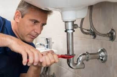 plumber fixing sink