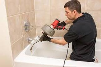 plumber snaking bathtub