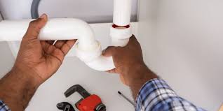 Plumber repairing sink pipe 